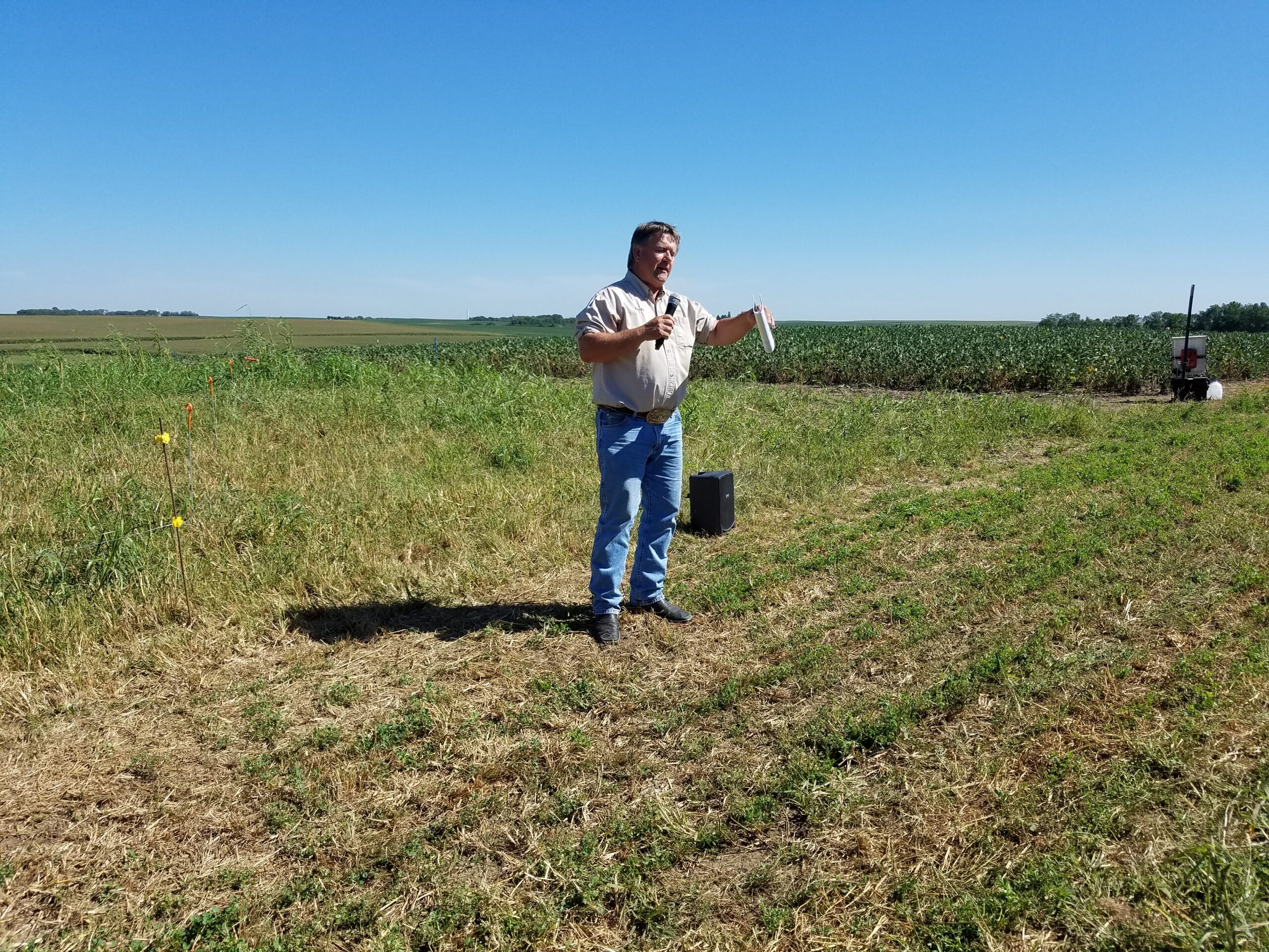 A photo of Kevin Sedivec speaking in a field.